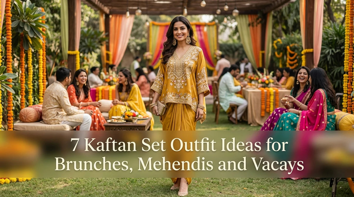 Stylish woman in kaftan stands foreground; friends chat, blurred marigold decor in background.