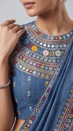 Close-up of floral hand embroidery and mirror work on blue denim saree blouse and border — thumbnail 2