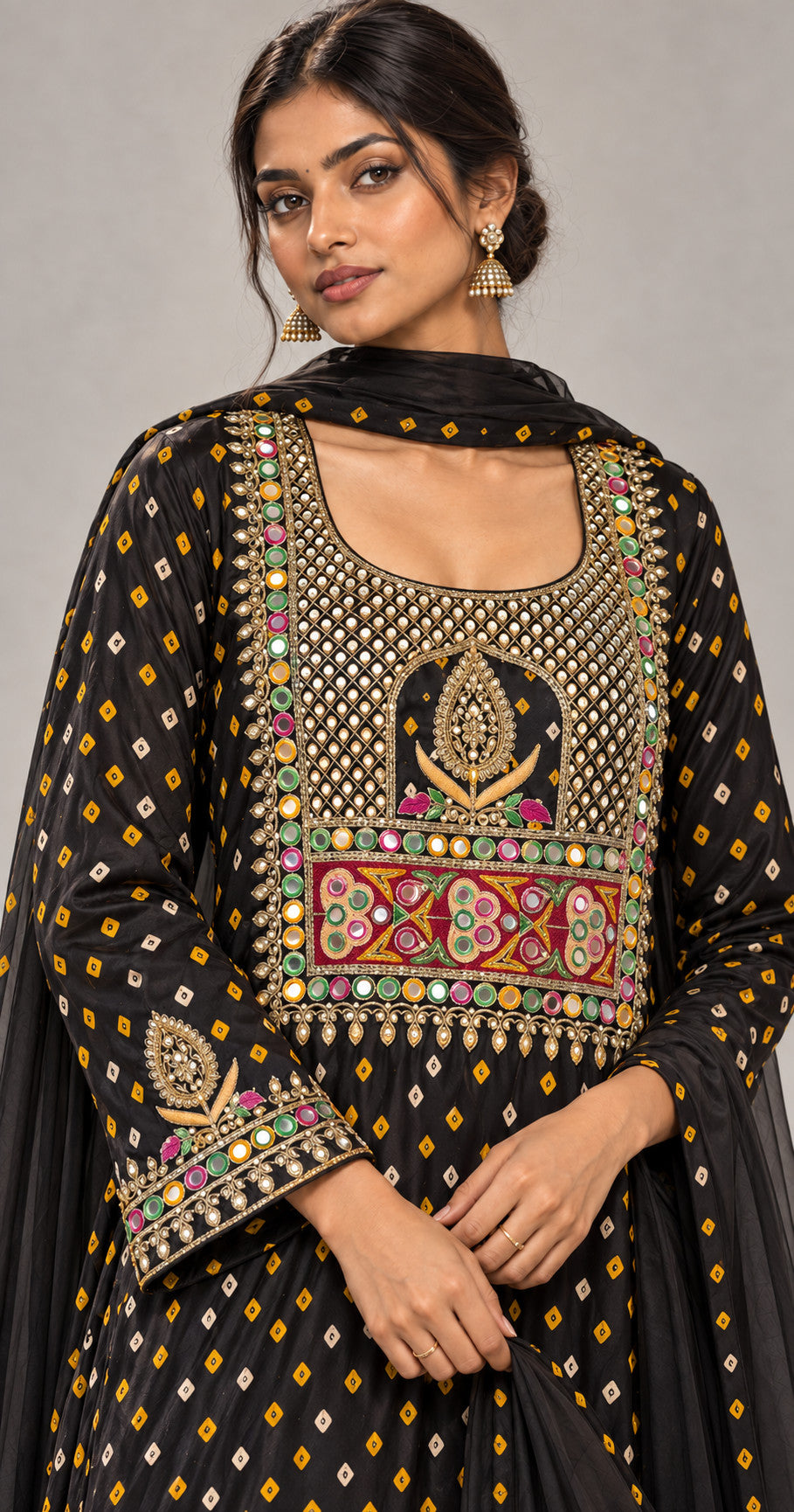 Close-up of hand-embroidered neckline and sleeve border on black bandhani modal silk