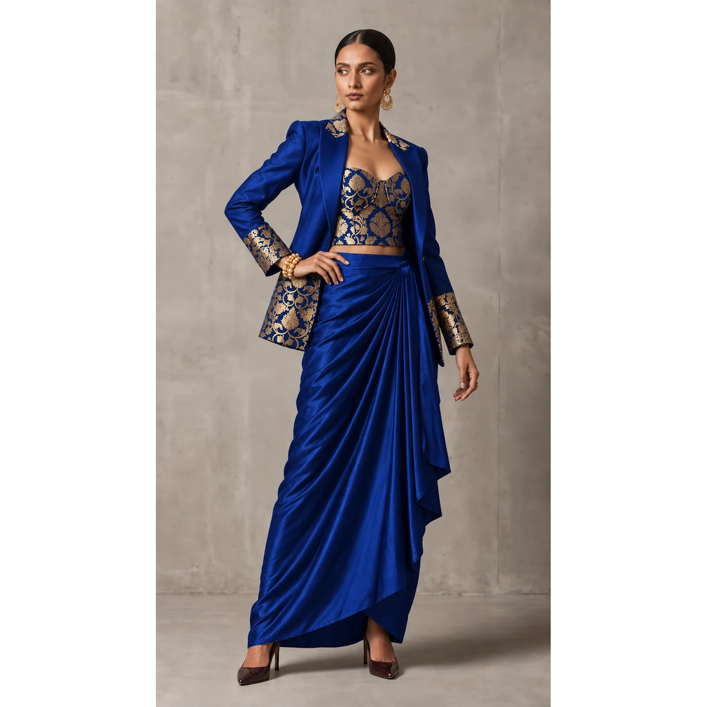 Royal Blue Banarasi Katan silk brocade three-piece set with modal silk blazer and draped skirt, full-length front with blazer; full photograph centered on a square white canvas