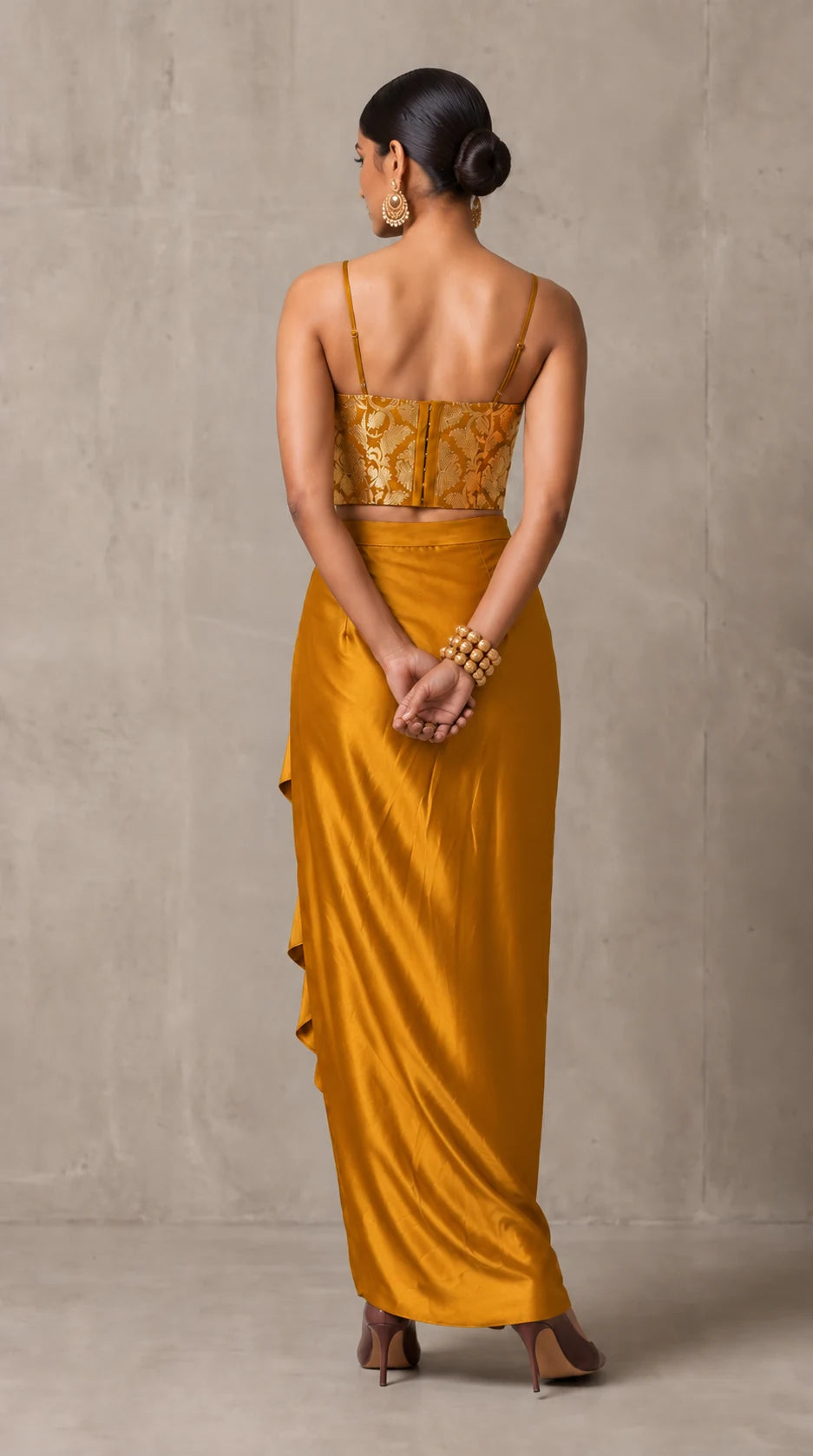 Ochre Gold Banarasi Katan silk brocade three-piece set with modal silk blazer and draped skirt, back view without blazer