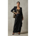 Black Banarasi Katan silk brocade three-piece set with modal silk blazer and draped skirt, full-length front with blazer; full photograph centered on a square white canvas