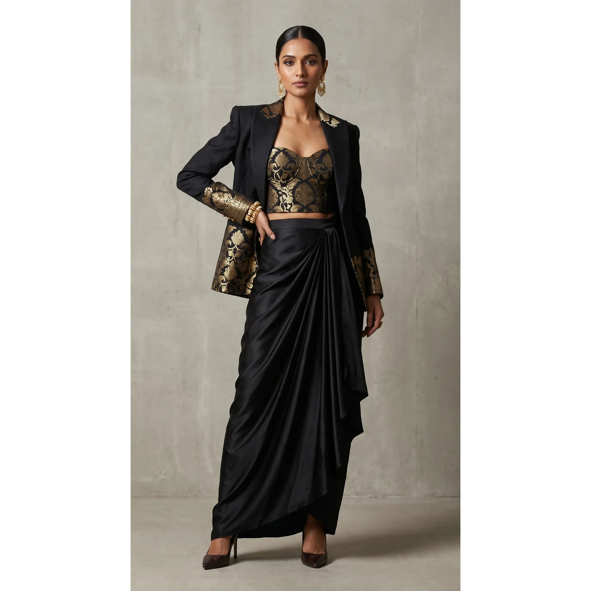 Black Banarasi Katan silk brocade three-piece set with modal silk blazer and draped skirt, full-length front with blazer; full photograph centered on a square white canvas
