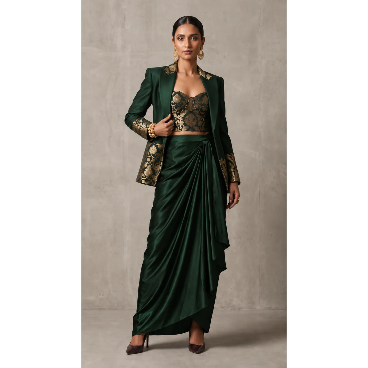 Deep Green Banarasi Katan silk brocade three-piece set with modal silk blazer and draped skirt, full-length front with blazer; full photograph centered on a square white canvas
